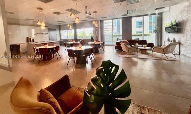 1200 Brickell Bay Drive, Unit 2008 Miami, FL 33131 - Photo 21 of 37 a living room with lots of furniture and a large window