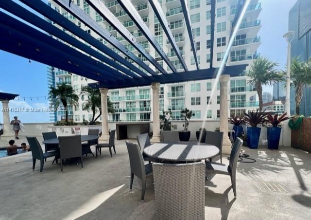 1200 Brickell Bay Drive, Unit 2008 Miami, FL 33131 - Photo 24 of 37 a view of a dining room with furniture window and outside view