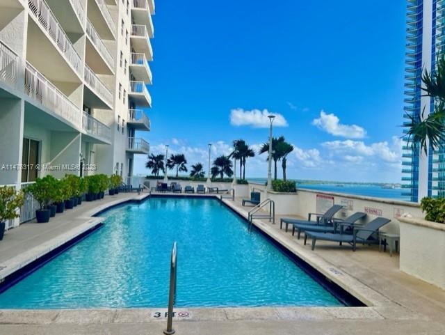 1200 Brickell Bay Drive, Unit 2008 Miami, FL 33131 - Photo 27 of 37 a view of a swimming pool and lounge chair