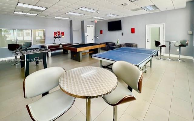 1200 Brickell Bay Drive, Unit 2008 Miami, FL 33131 - Photo 29 of 37 a living room with lots of furniture and a wooden floor