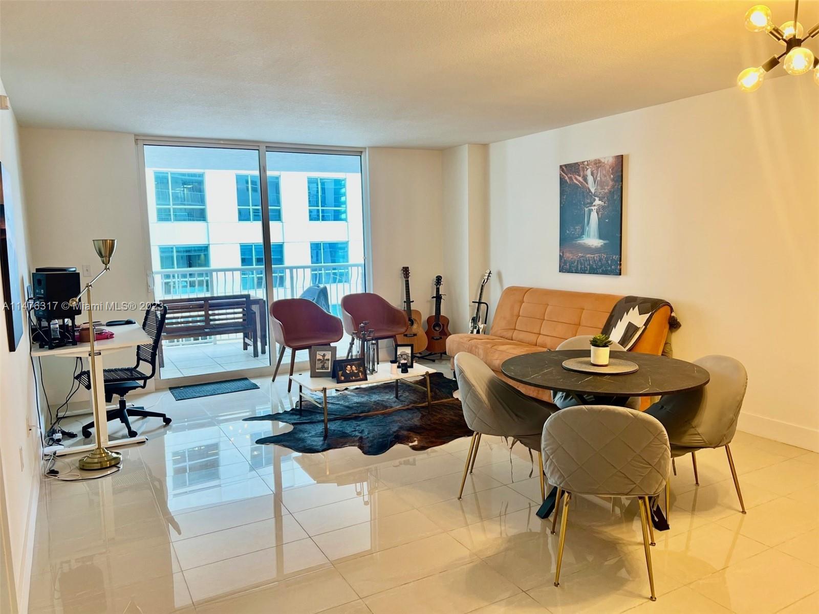1200 Brickell Bay Drive, Unit 2008 Miami, FL 33131 - Photo 3 of 37 a living room with furniture and floor to ceiling windows