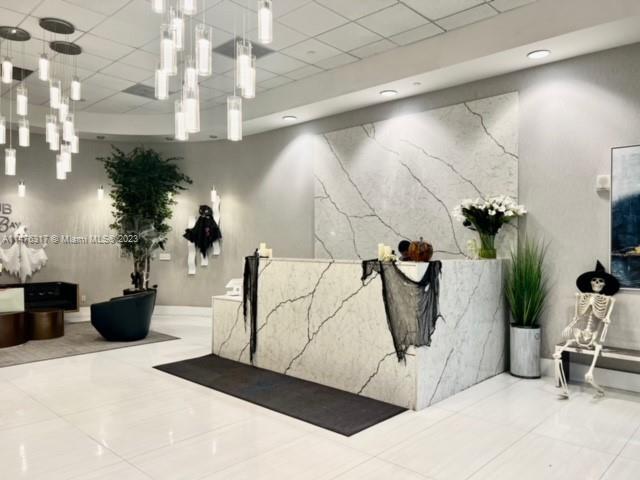 1200 Brickell Bay Drive, Unit 2008 Miami, FL 33131 - Photo 36 of 37 a picture of a flower room with a rug and a chandelier