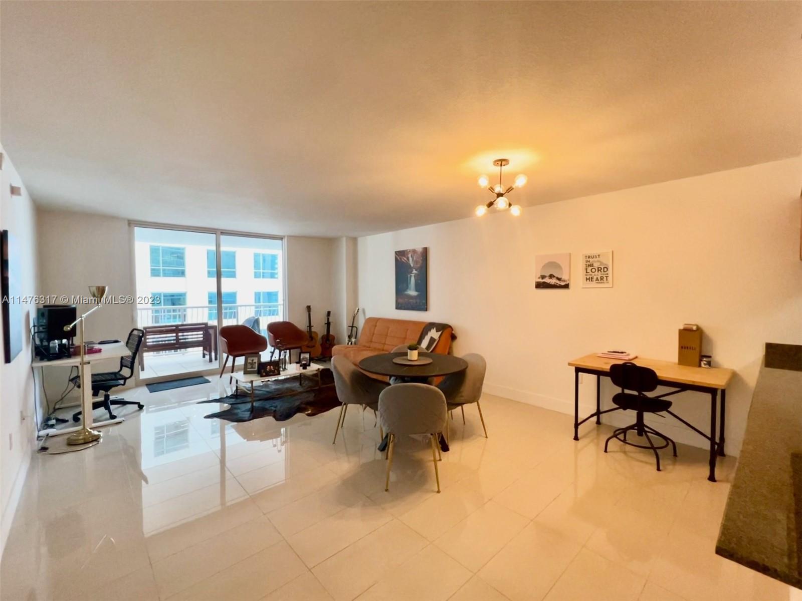 1200 Brickell Bay Drive, Unit 2008 Miami, FL 33131 - Photo 5 of 37 a living room with furniture