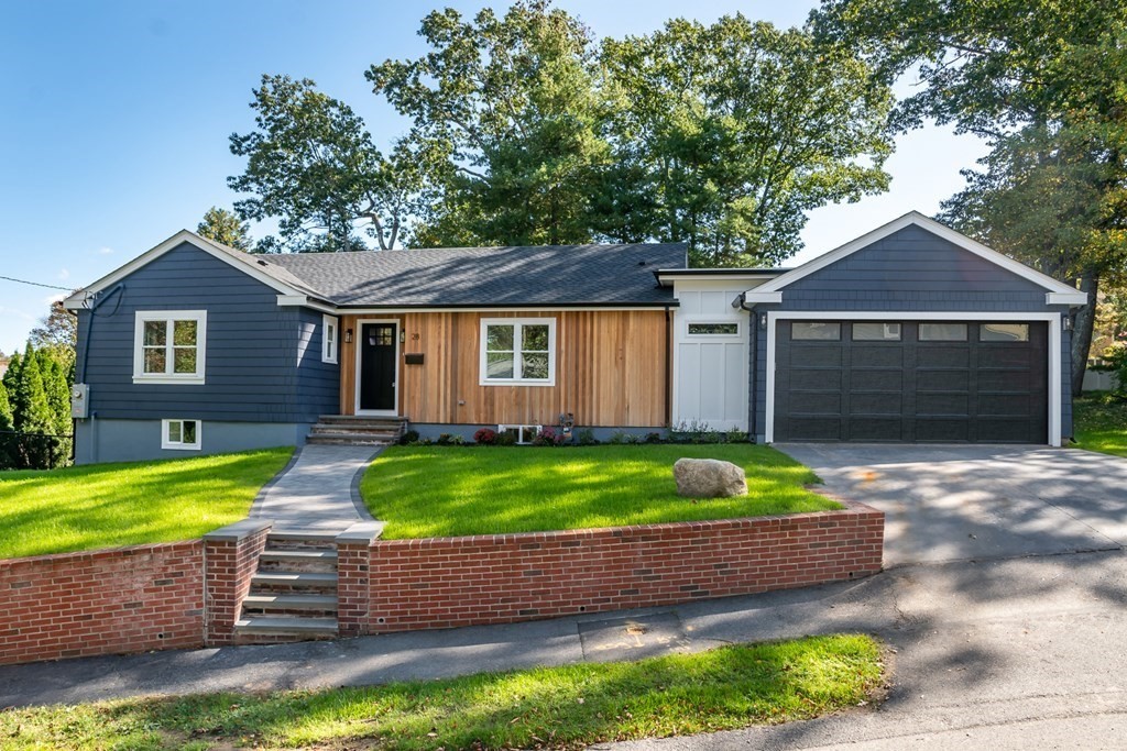 28 Perry Drive Needham, MA 02492 - Photo 1 of 35 a front view of a house with a yard and garage