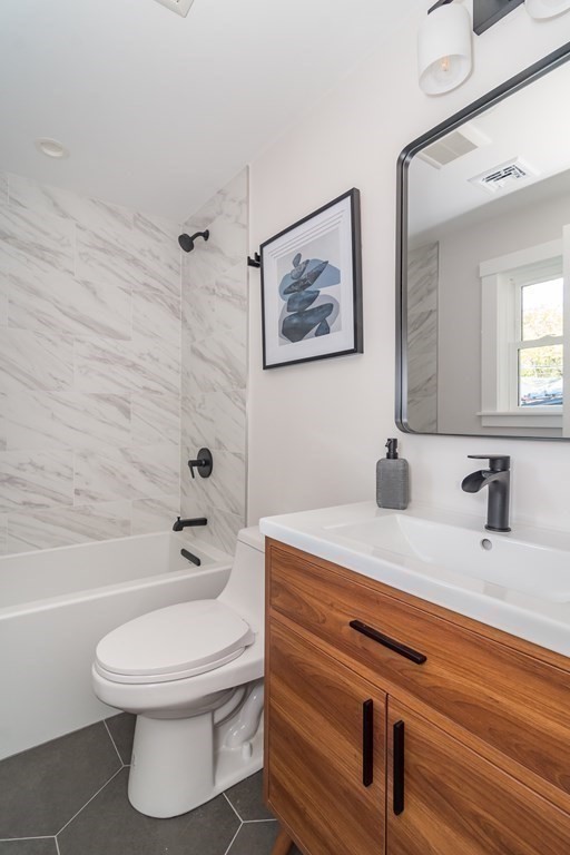 28 Perry Drive Needham, MA 02492 - Photo 23 of 35 a bathroom with a sink a toilet and shower