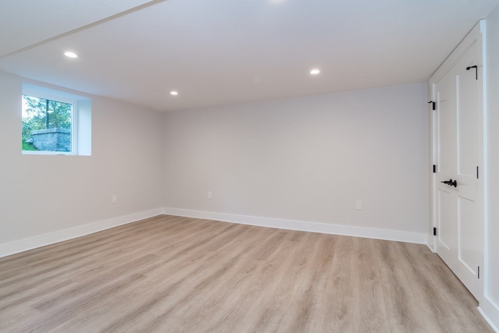 28 Perry Drive Needham, MA 02492 - Photo 27 of 35 an empty room with wooden floor and windows