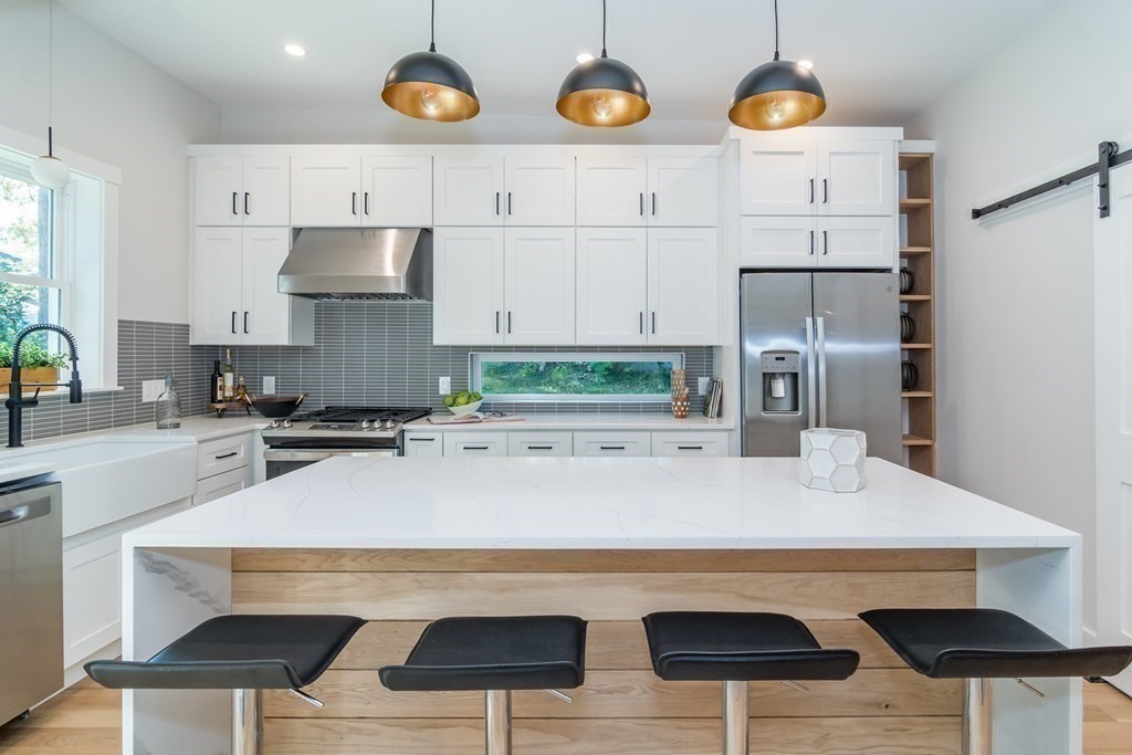 28 Perry Drive Needham, MA 02492 - Photo 9 of 35 a kitchen with a table and chairs in it
