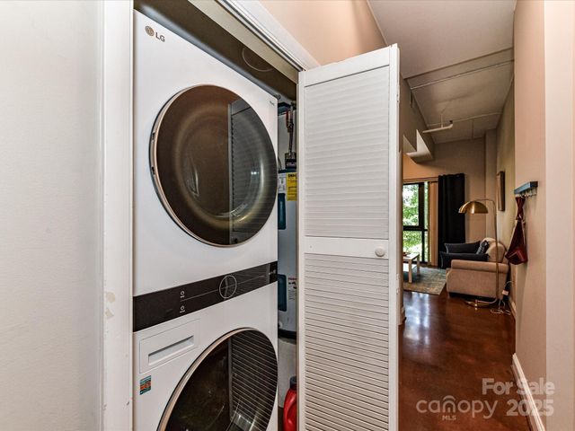 a kitchen with granite countertop cabinets stainless steel appliances and a window