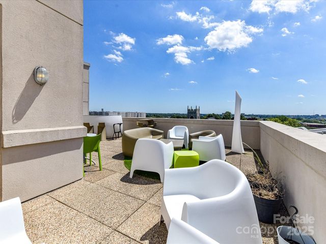 a balcony with furniture and a lamp