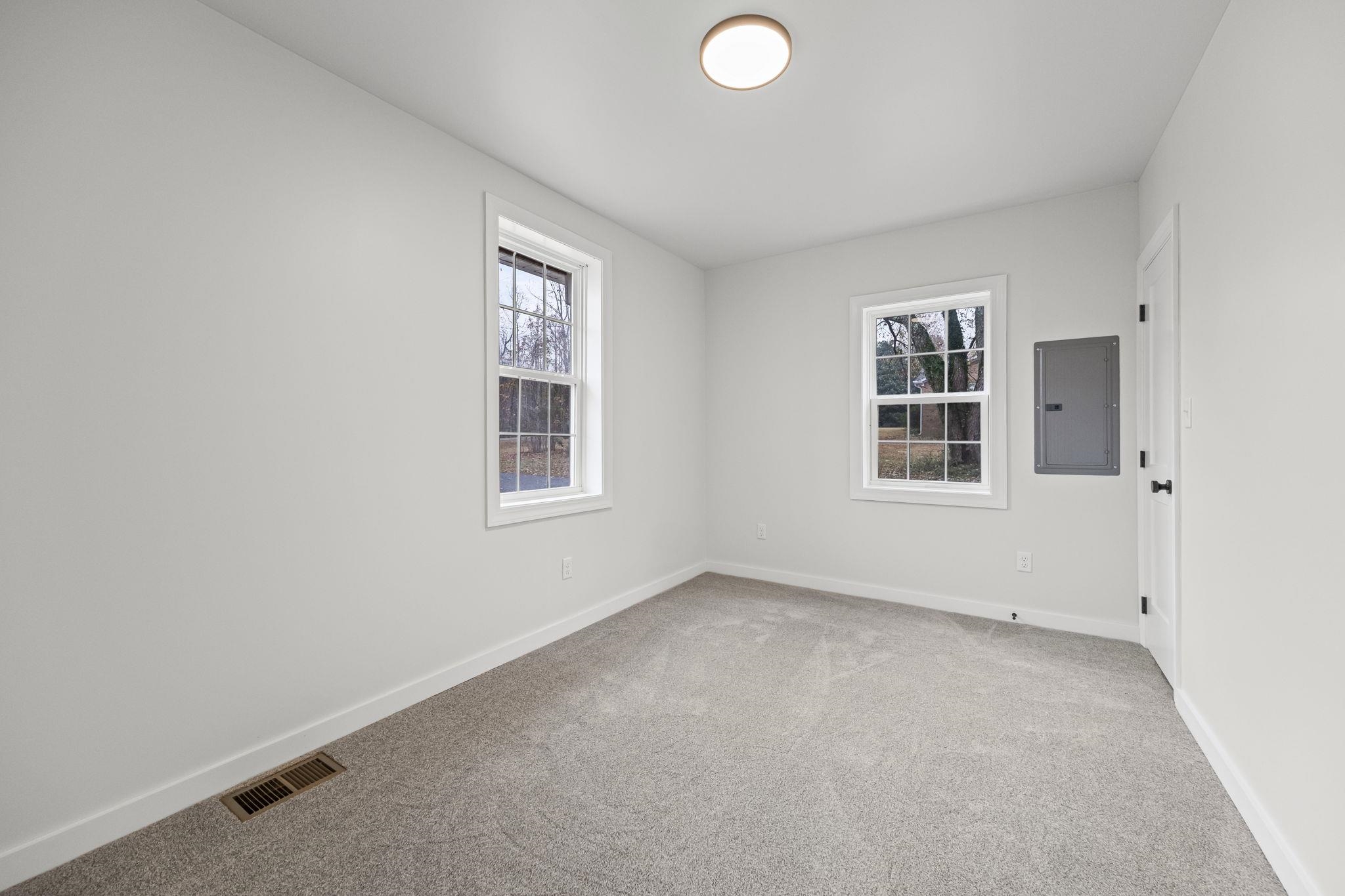 835 Curve Woodville Road Gates, TN 38037 - Photo 21 of 30 Unfurnished room featuring electric panel, light carpet, and healthy amount of natural light