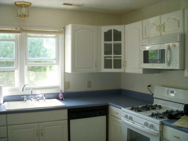 521 Old Murfreesboro Road Manchester, TN 37355 - Photo 6 of 15 Main level kitchen offers lovely country white cabinets with glass fronts. You will enjoy spending time in this lovely kitchen.