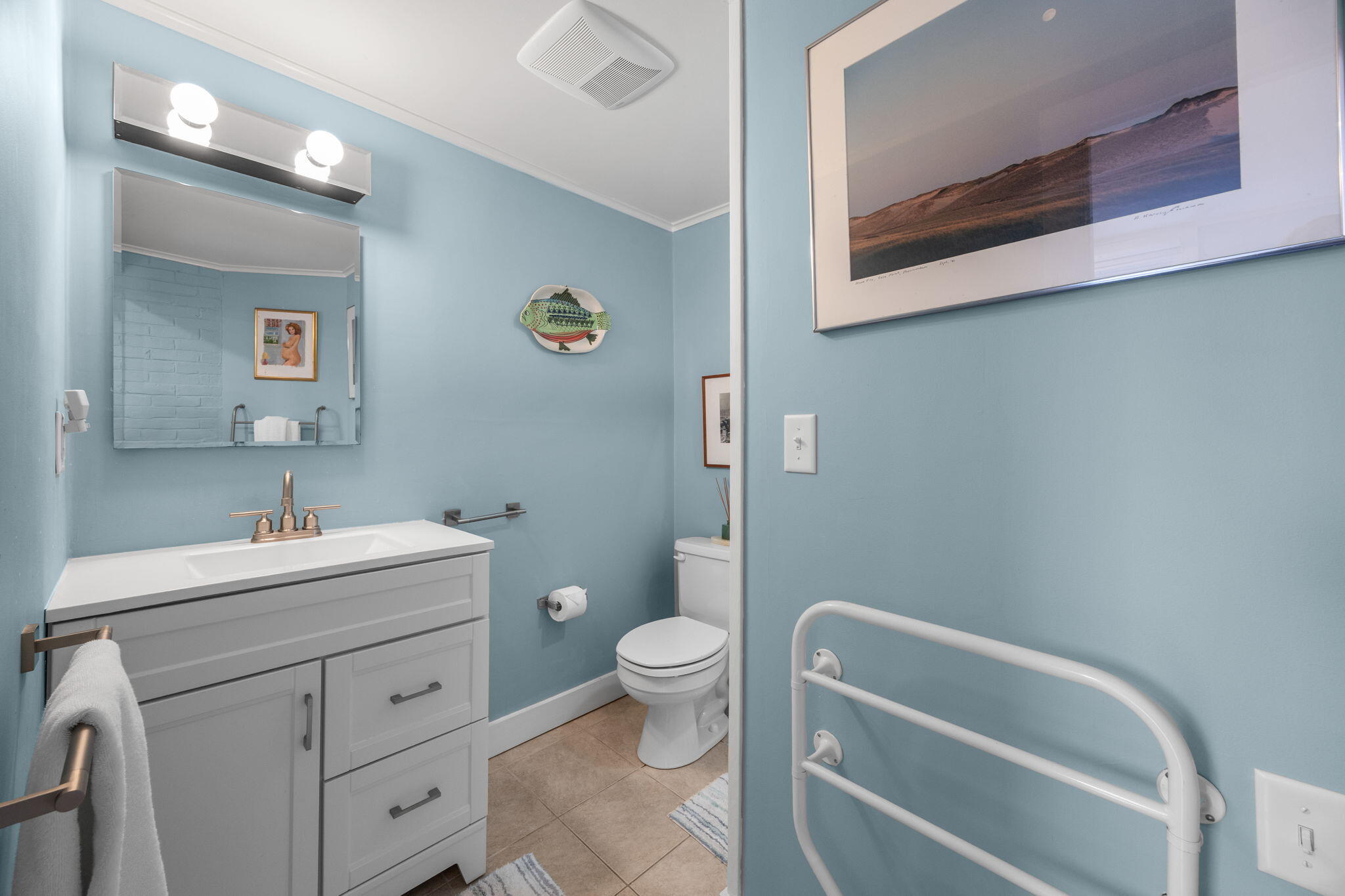 535 Commercial Street, Unit 2 Provincetown, MA 02657 - Photo 32 of 52 a bathroom with a sink a toilet and a mirror