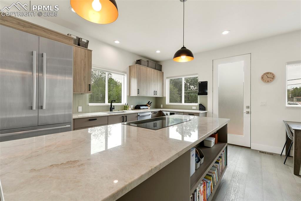 50 Sommerlyn Road Colorado Springs, CO 80906 - Photo 12 of 39 a large kitchen with kitchen island a large counter top appliances and cabinets