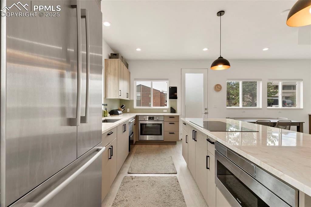 50 Sommerlyn Road Colorado Springs, CO 80906 - Photo 13 of 39 a large white kitchen with a large window