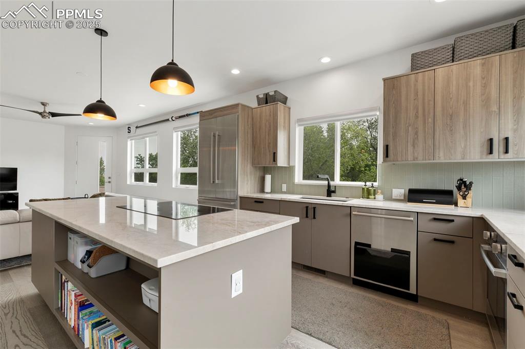 50 Sommerlyn Road Colorado Springs, CO 80906 - Photo 14 of 39 a kitchen with a sink a stove and a refrigerator