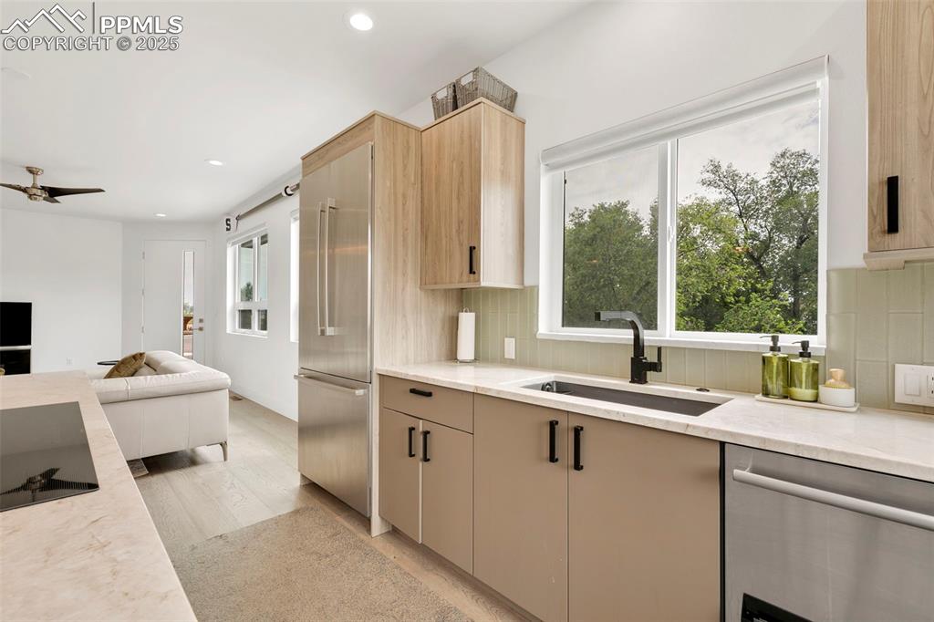 50 Sommerlyn Road Colorado Springs, CO 80906 - Photo 16 of 39 a kitchen with a sink and a refrigerator