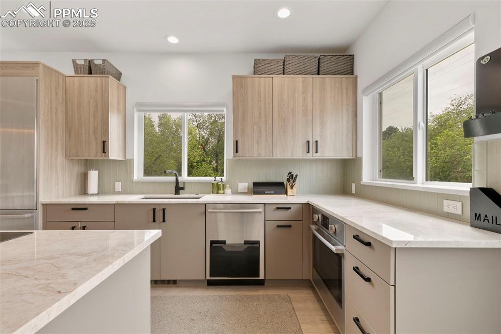 50 Sommerlyn Road Colorado Springs, CO 80906 - Photo 17 of 39 a kitchen with a sink stove and cabinets