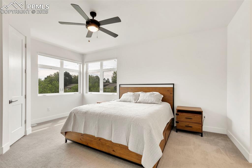 50 Sommerlyn Road Colorado Springs, CO 80906 - Photo 20 of 39 a bedroom with a bed and a ceiling fan