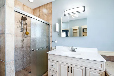 a bathroom with a shower sink and mirror