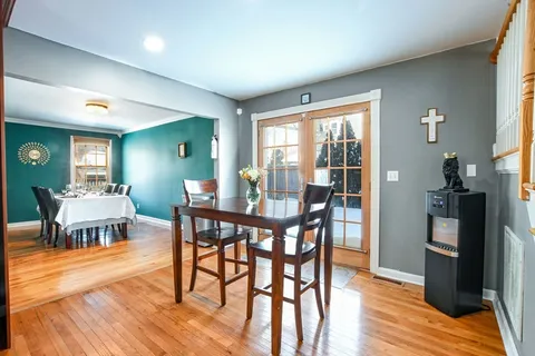 a view of a dining room with furniture window and wooden floor