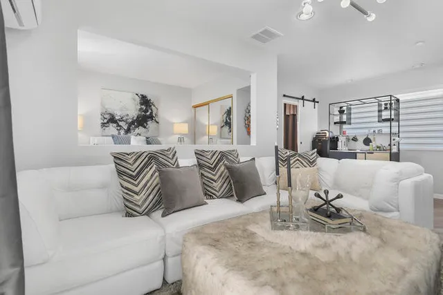 a bedroom with a large bed and a couch