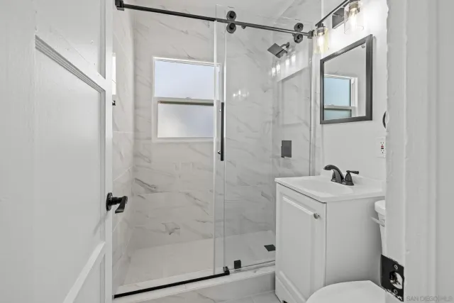 a bathroom with a sink toilet and shower