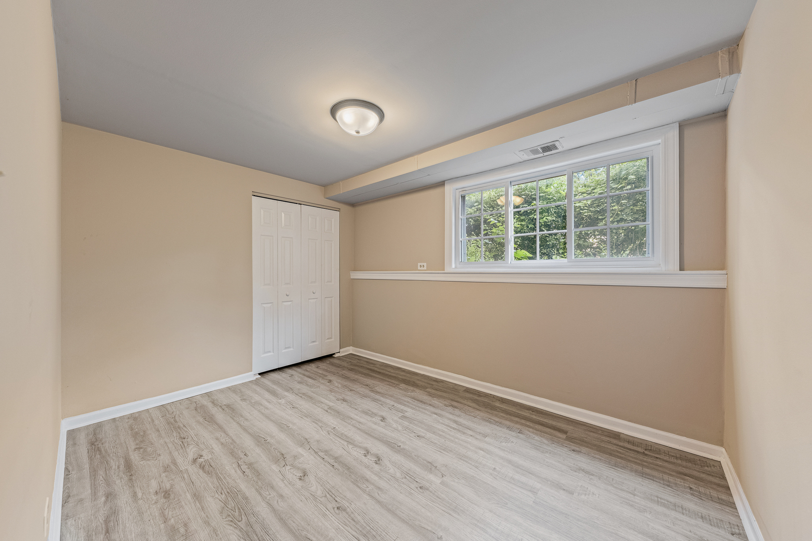 303 Springfield Street Park Forest, IL 60466 - Photo 12 of 16 an empty room with wooden floor and windows