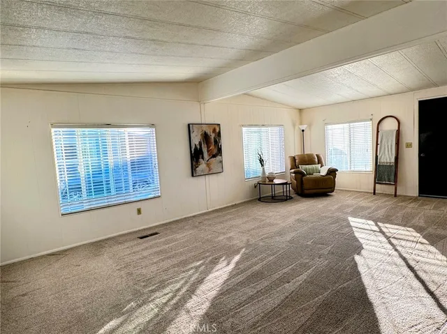 a view of a livingroom with furniture and windows