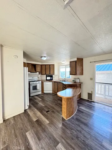 a living room with furniture and view kitchen