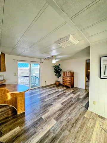 a view of a kitchen with furniture and wooden floor