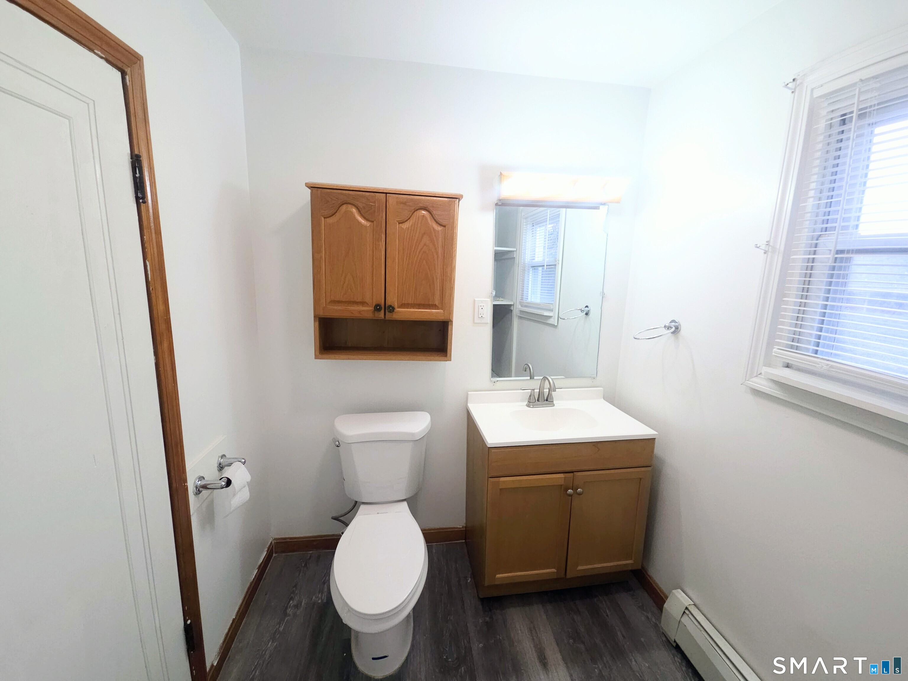 387 Putnam Pike Killingly, CT 06241 - Photo 13 of 17 a bathroom with a toilet sink and mirror
