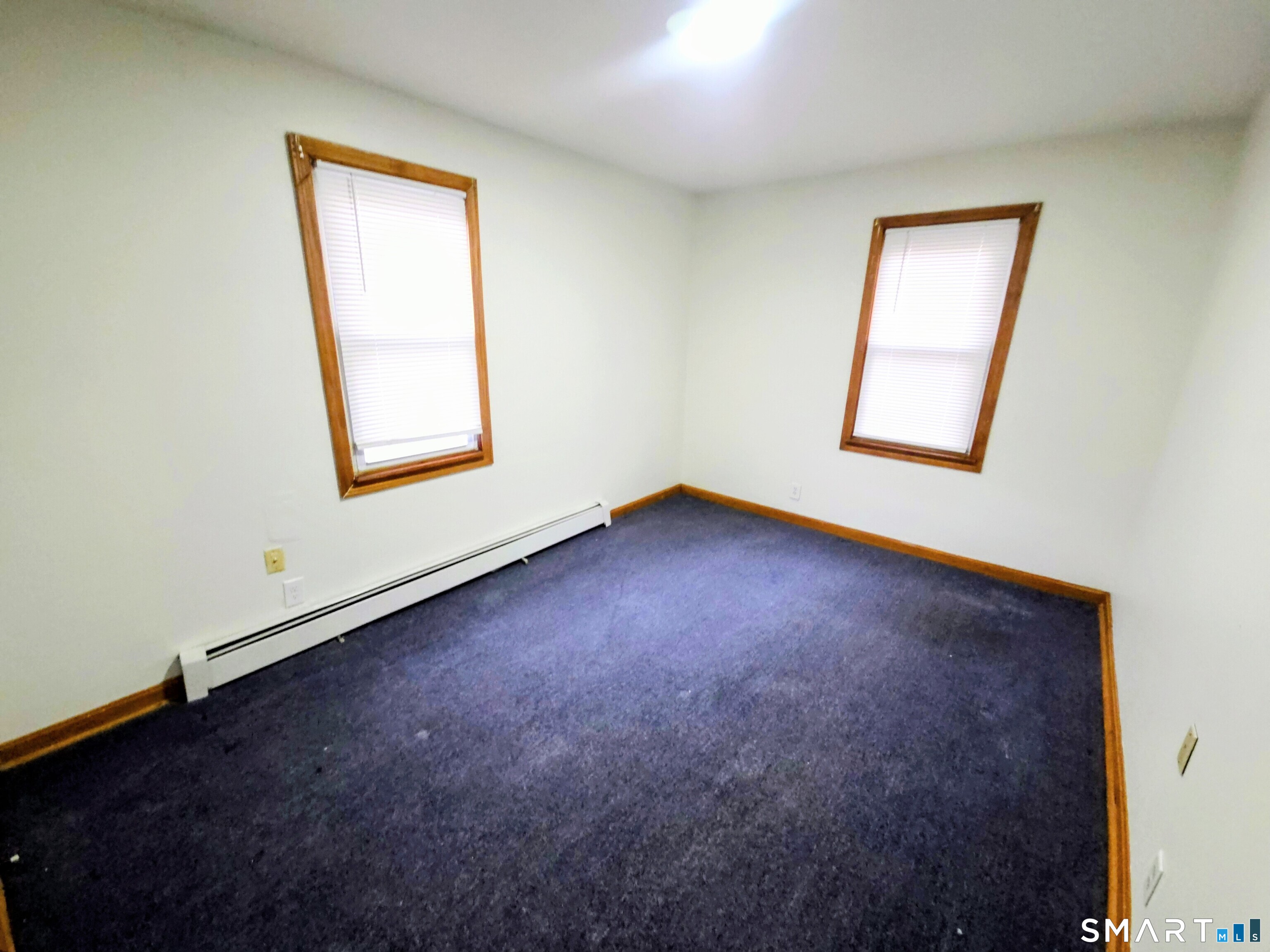 387 Putnam Pike Killingly, CT 06241 - Photo 14 of 17 an empty room with windows and closet