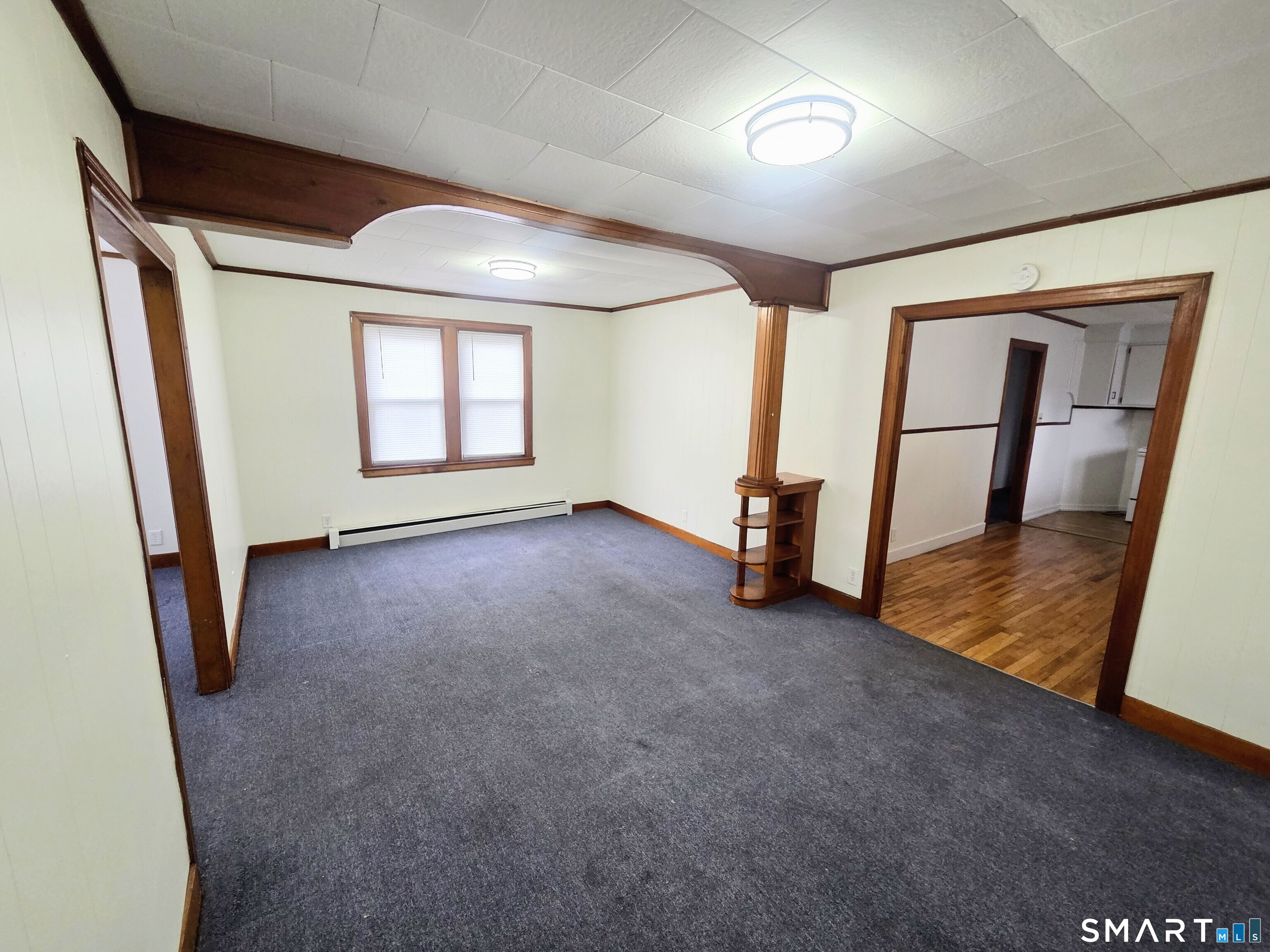 387 Putnam Pike Killingly, CT 06241 - Photo 7 of 17 wooden floor in an empty room with a window