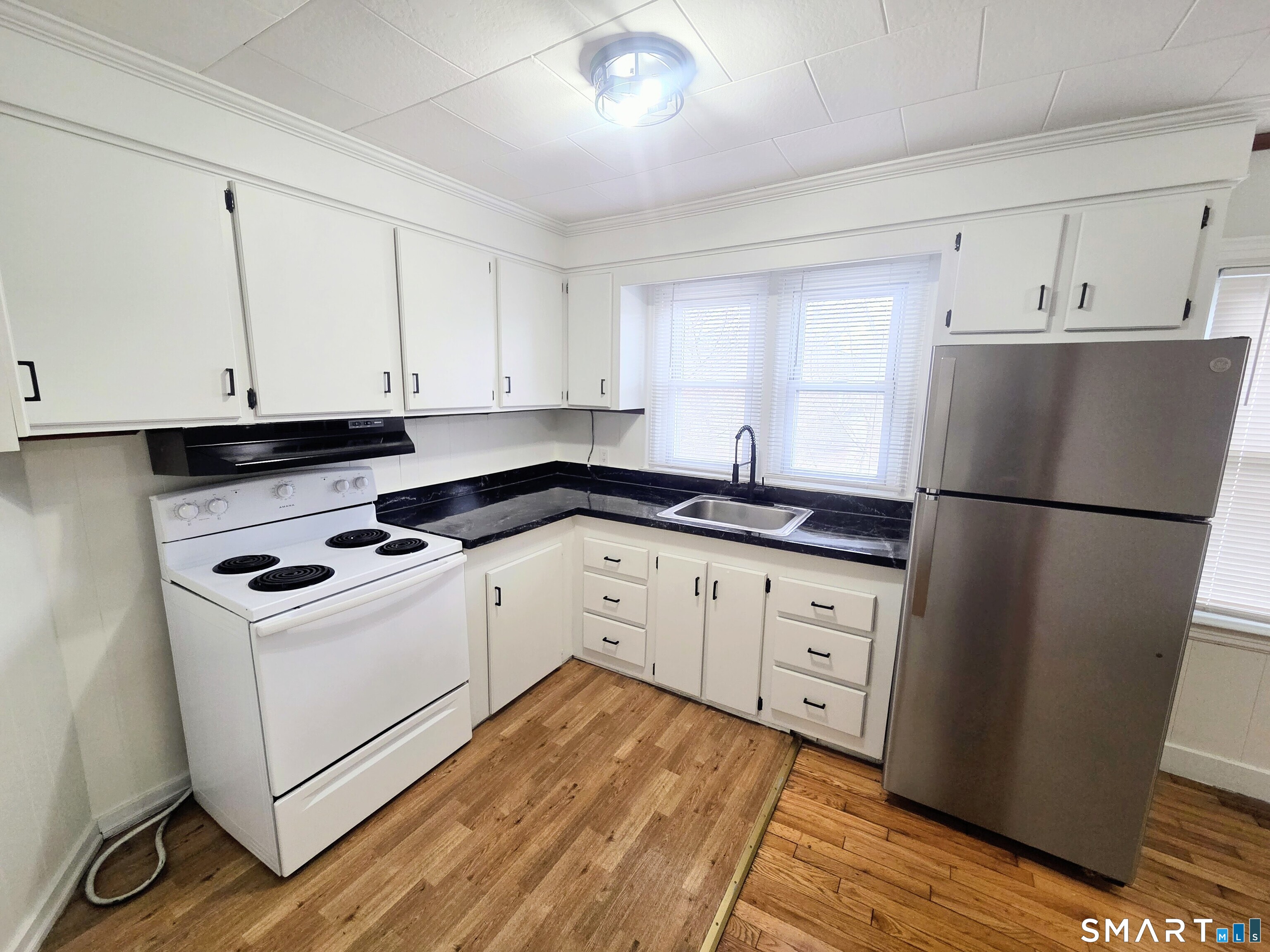 387 Putnam Pike Killingly, CT 06241 - Photo 9 of 17 a kitchen with cabinets appliances and a window