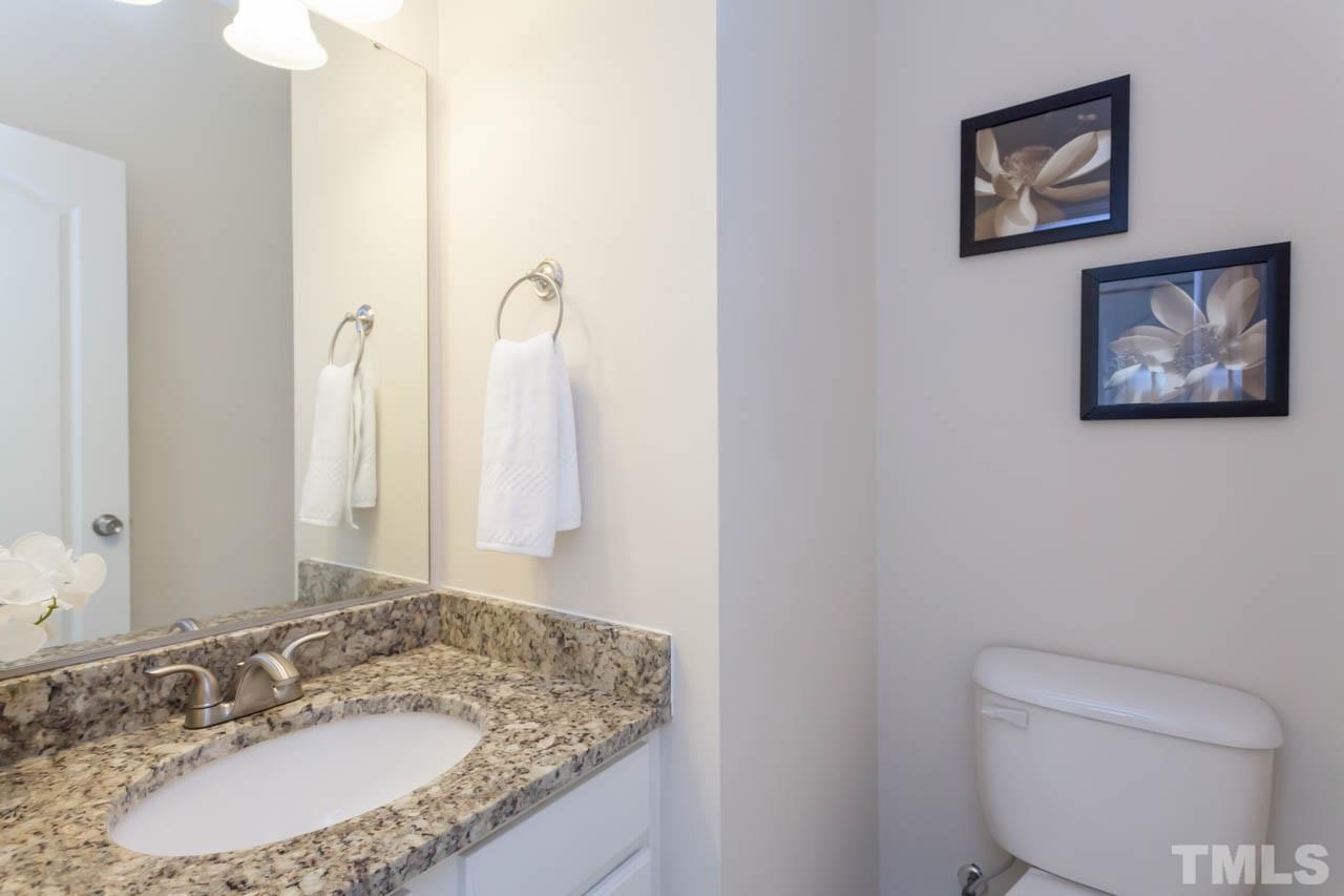 2929 Ranburne Drive Raleigh, NC 27610 - Photo 14 of 22 a bathroom with a granite countertop sink and a mirror