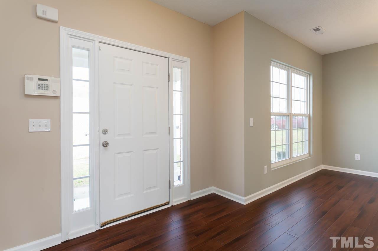 2929 Ranburne Drive Raleigh, NC 27610 - Photo 5 of 22 an empty room with wooden floor and windows