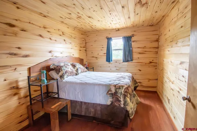 a bedroom with a bed and a table