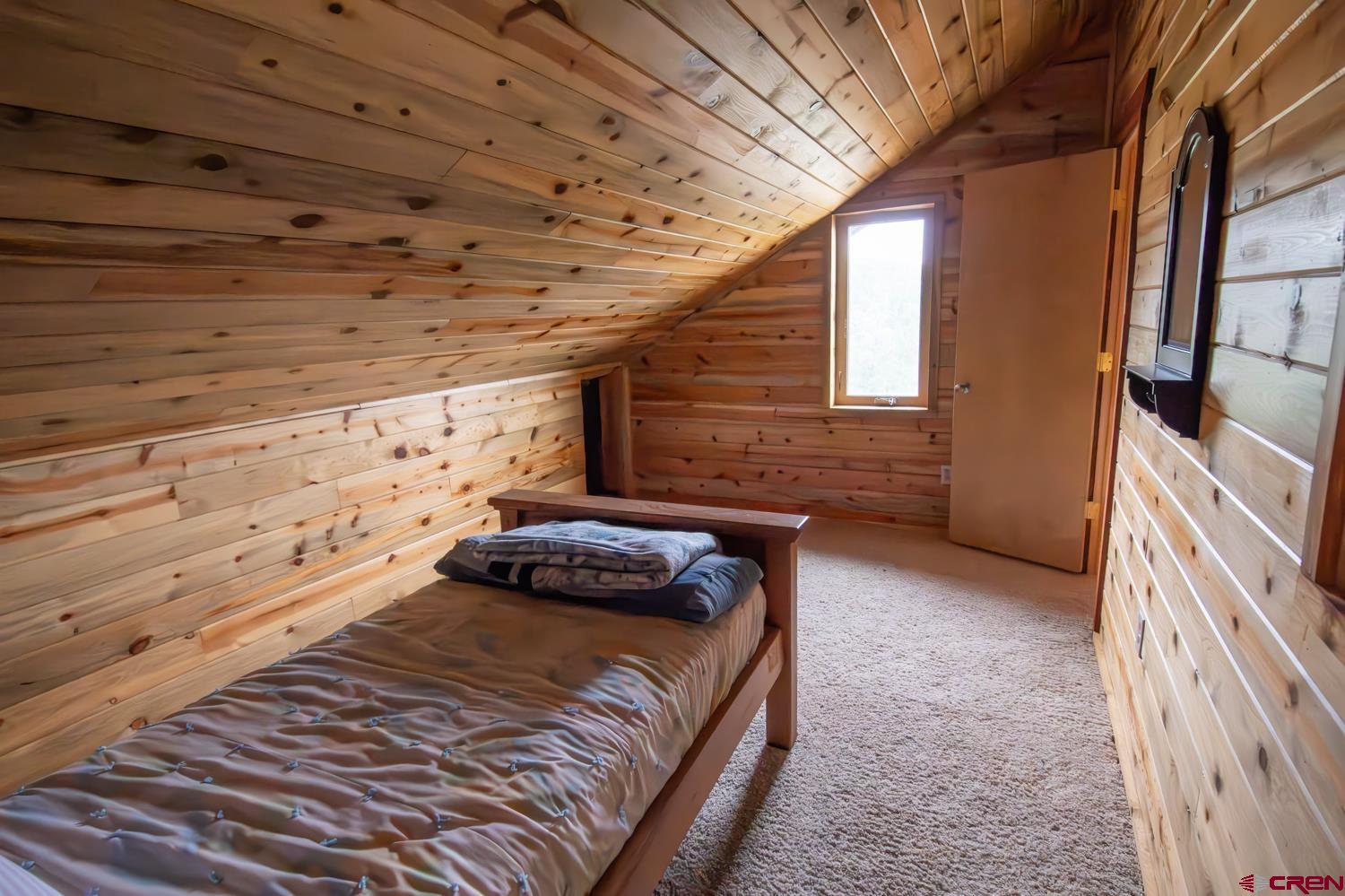 26779 Fs Road Norwood, CO 81423 - Photo 16 of 44 a bedroom with a bed and a walk in closet