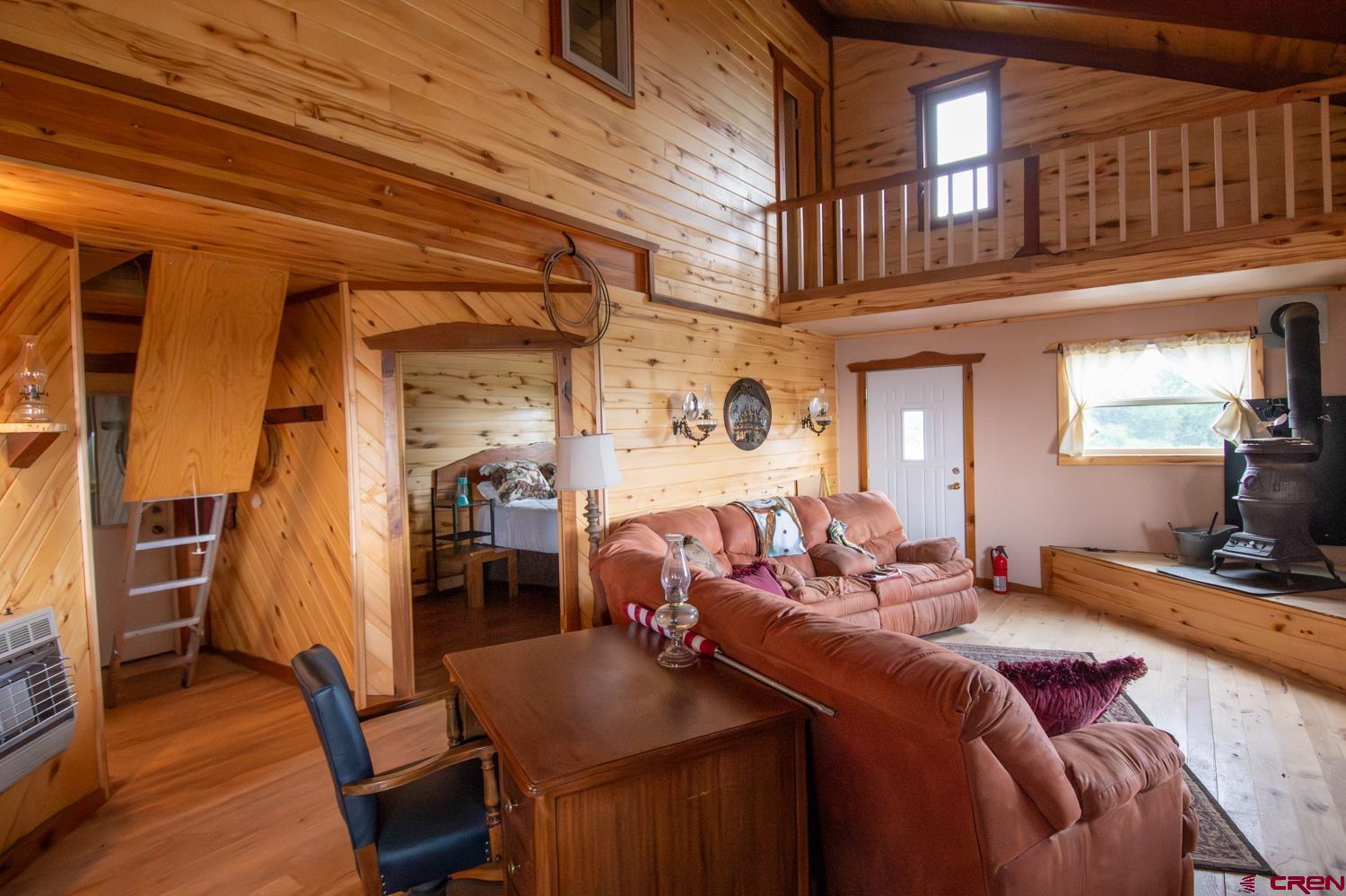 26779 Fs Road Norwood, CO 81423 - Photo 7 of 44 a living room with furniture a flat screen tv and dresser