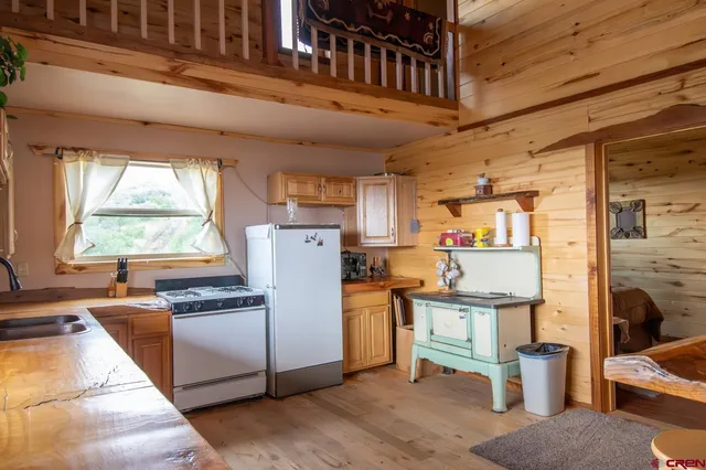 a kitchen with a refrigerator and a stove