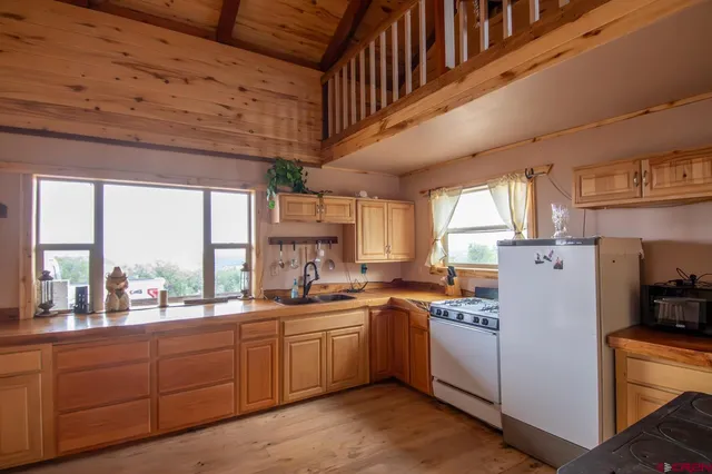 a kitchen with sink a window and cabinets