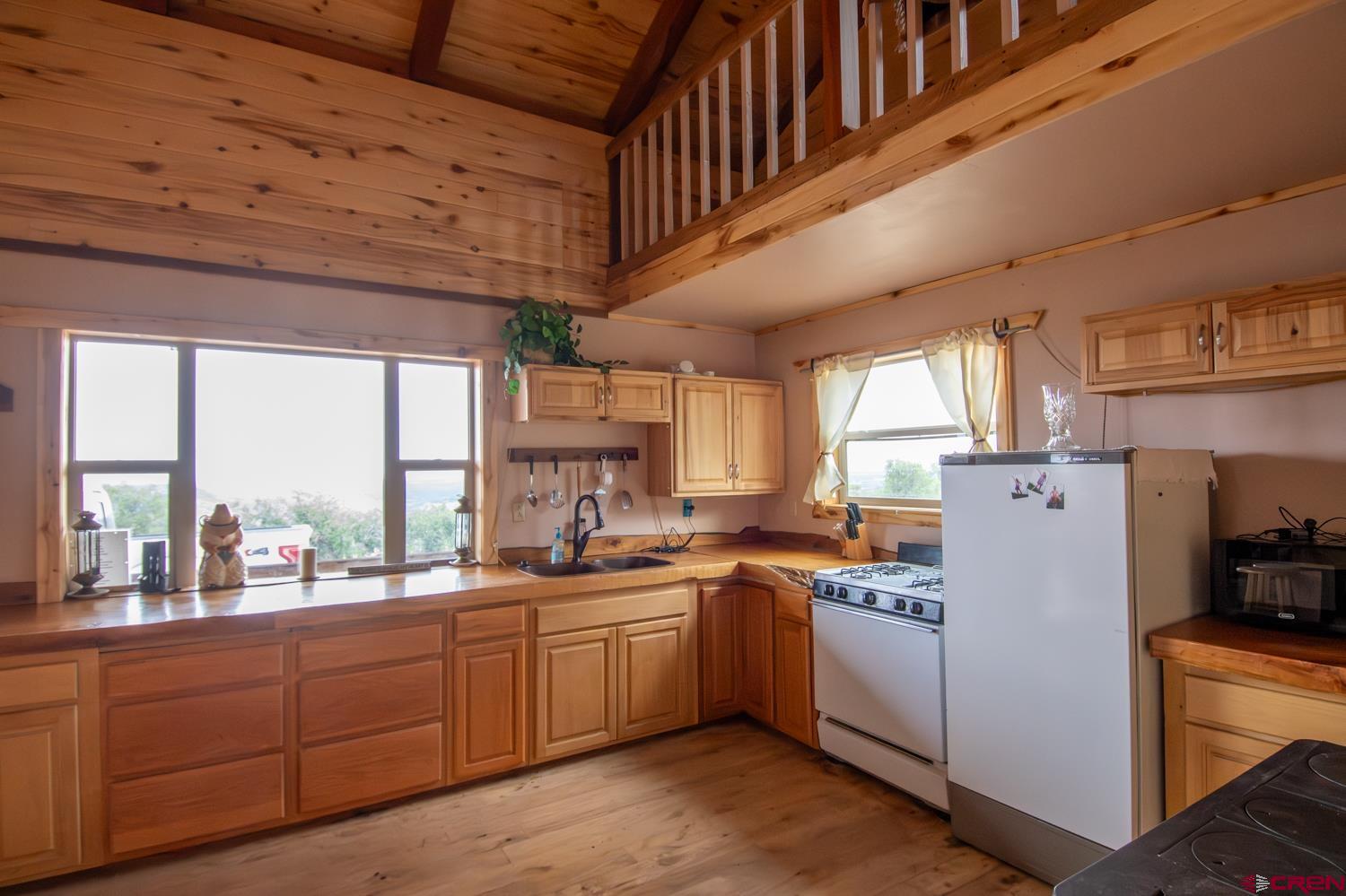 26779 Fs Road Norwood, CO 81423 - Photo 9 of 44 a kitchen with sink a window and cabinets
