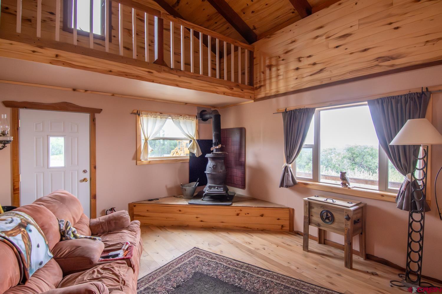26779 Fs Road Norwood, CO 81423 - Photo 10 of 44 a living room with furniture a window and a chandelier