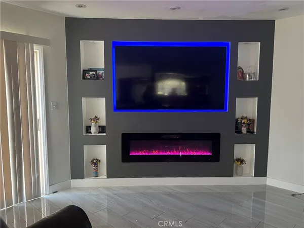 a living room with a fireplace and a fireplace
