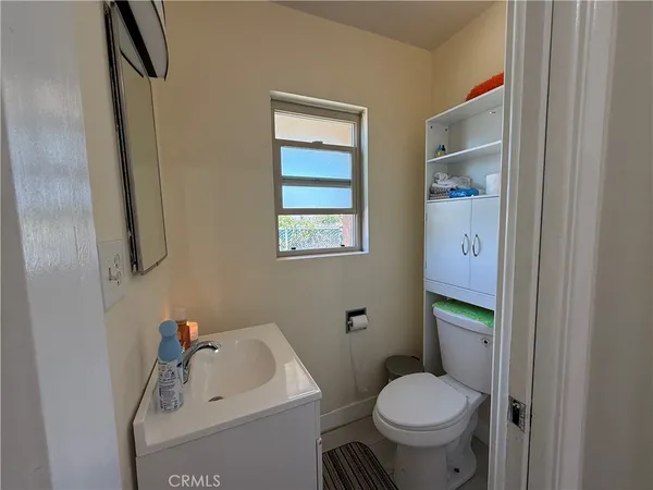 a white toilet sitting next to a bathroom sink