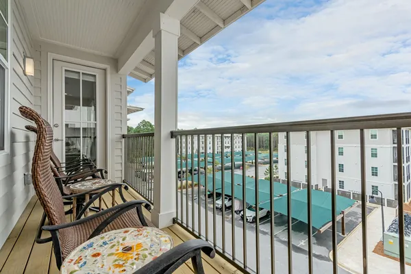 a view of a balcony with wooden floor