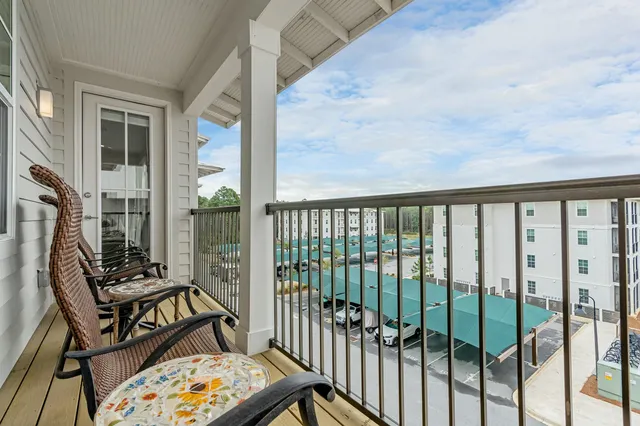 a view of a balcony with wooden floor