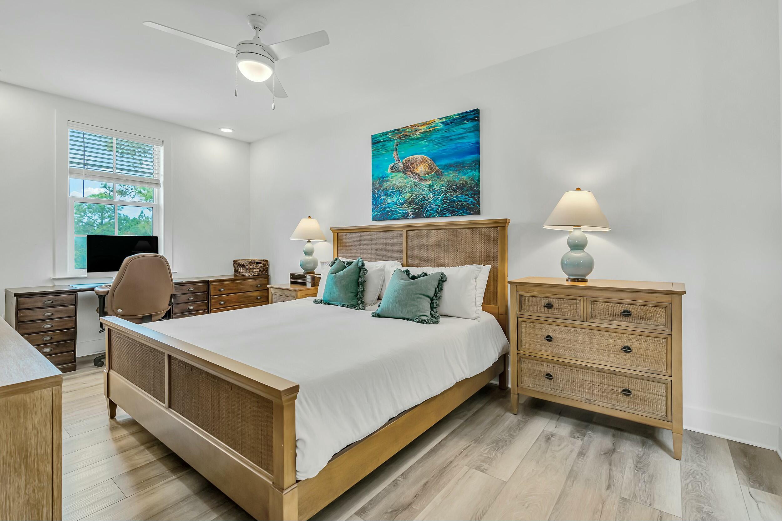 179 South County Highway 393, Unit 445 Santa Rosa Beach, FL 32459 - Photo 14 of 50 a bedroom with a bed and wooden floor