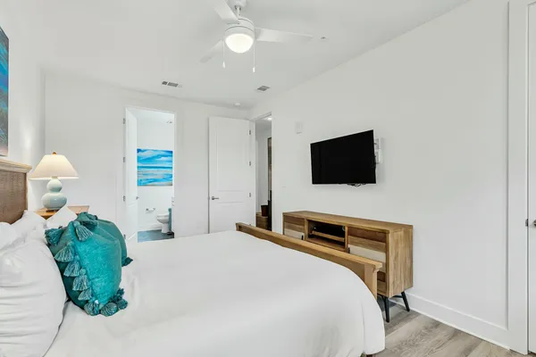 a bedroom with a bed and a flat screen tv