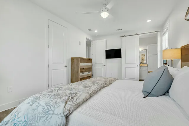 a bedroom with a large bed and flat screen tv